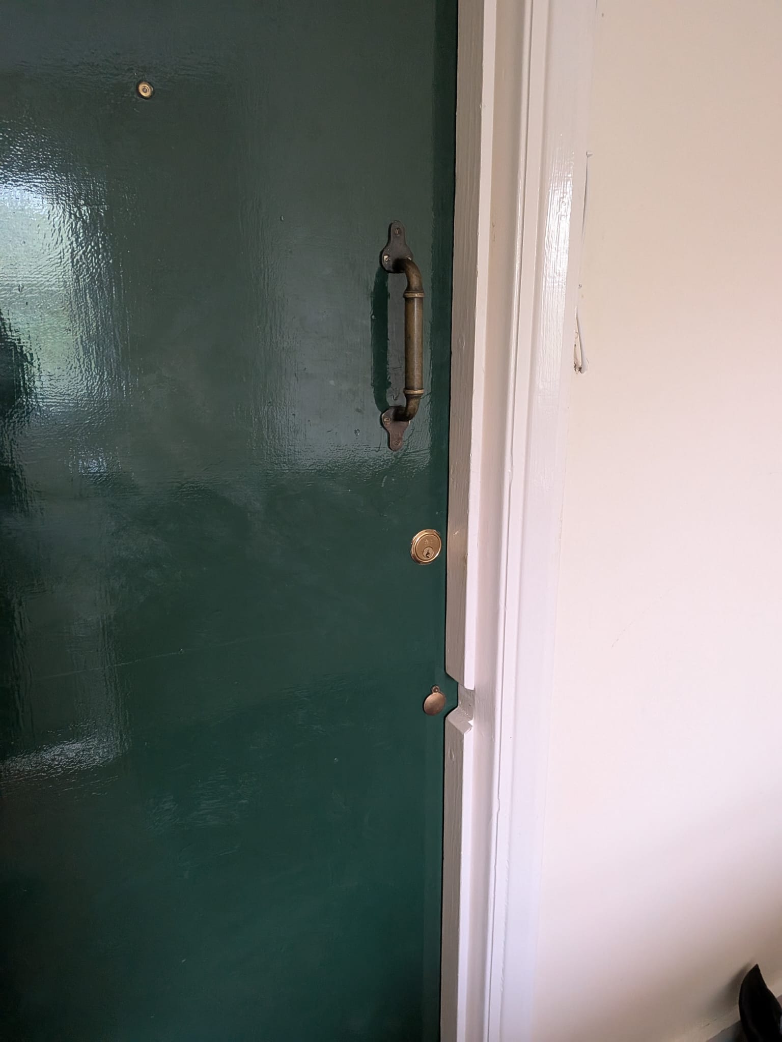 Completed green entrance door with heritage pull handle